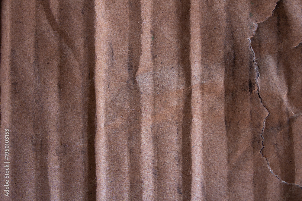 Fototapeta premium Torn Corrugated Cardboard Texture with Vertical Ridges and Rough Edge