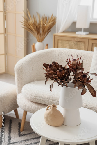Vase with dried flowers on ...
