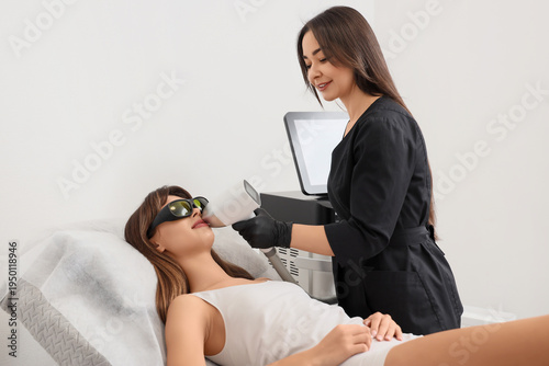 Female cosmetologist perfor...