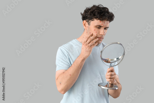 Ill young man with mirror l...
