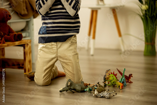 Photos Little toddler child, boy,  pee in his pants while playing with toys, child dist