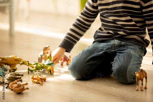 Little toddler child, boy,  pee in his pants while playing with toys, child distracted and forget to go to the toilet