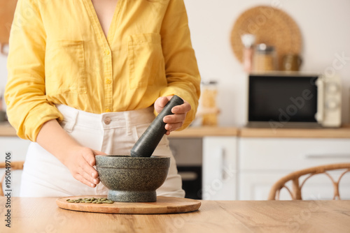 Woman grinding pumpkin seed...