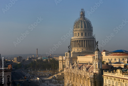 Morning light illuminates the historic skyline of Old Havana,where the ornate façade of the Gran Teatro de La Habana stands beside the iconic dome of the El Capitolio, reflecting the rich architecture