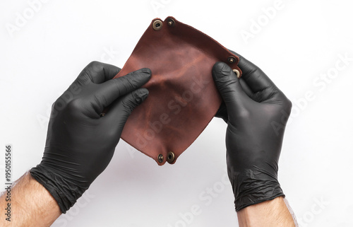 Tanner holds a leather organizer on a white background