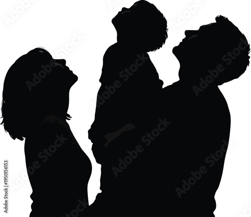 Silhouette of a happy family with a father holding a child up looking at the sky