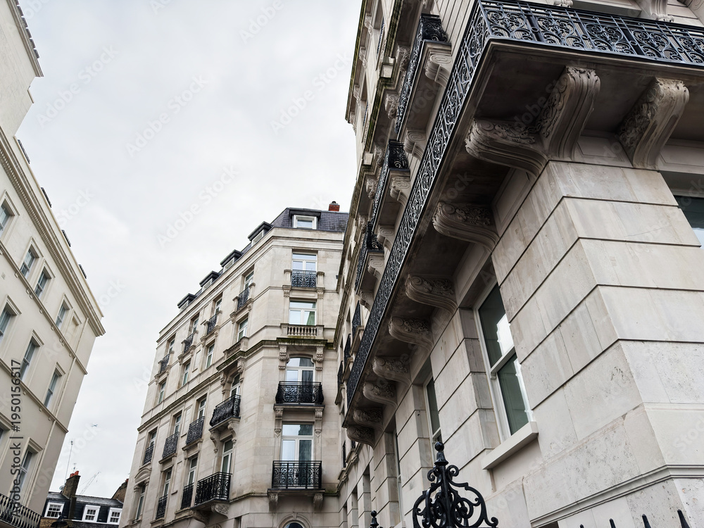 Fototapeta premium Elegant London street with classic stone buildings and ornate wrought iron balconies in the city center