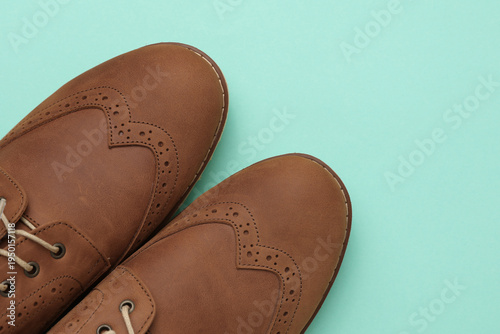 Φωτογραφία Brown leather brogue boots on a blue background