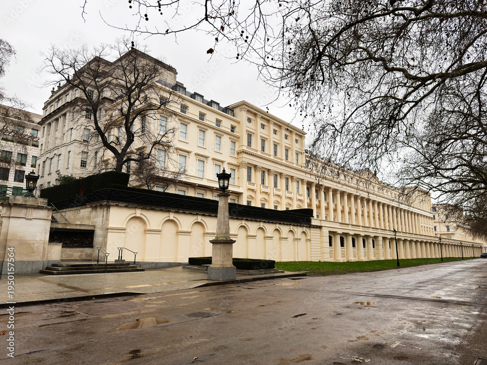 Fototapeta premium Historic white building with long colonnade Carlton House Terrace along a quiet London street in a refined urban setting