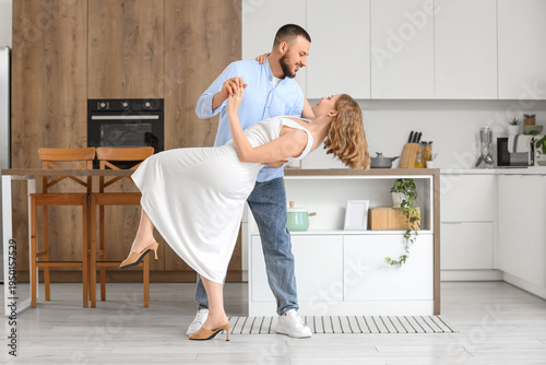 Young couple dancing near v...