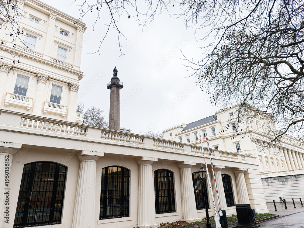 Fototapeta premium Historic neoclassical Carlton House Terrace building with colonnade and statue in London, UK, an elegant urban facade scene