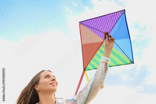 Young happy woman flying ki...