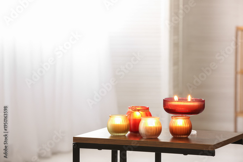 Burning candles on wooden t...