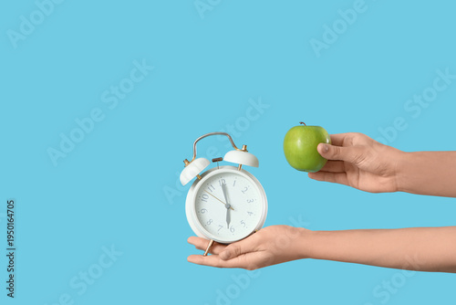Female hand with alarm cloc...