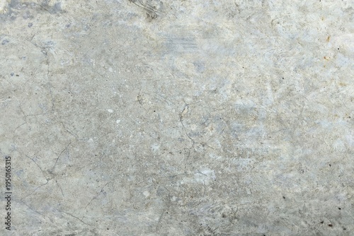 Polished gray concrete wall texture with subtle cracks and weathered industrial finish. Seamless cement floor background for architectural design, grunge backdrop, or urban construction concept.