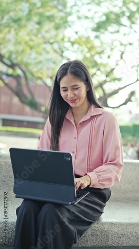 Smiling young woman talking on a smartphone outdoors in an urban area, expressing friendly communication, mobile connectivity, and modern digital lifestyle.