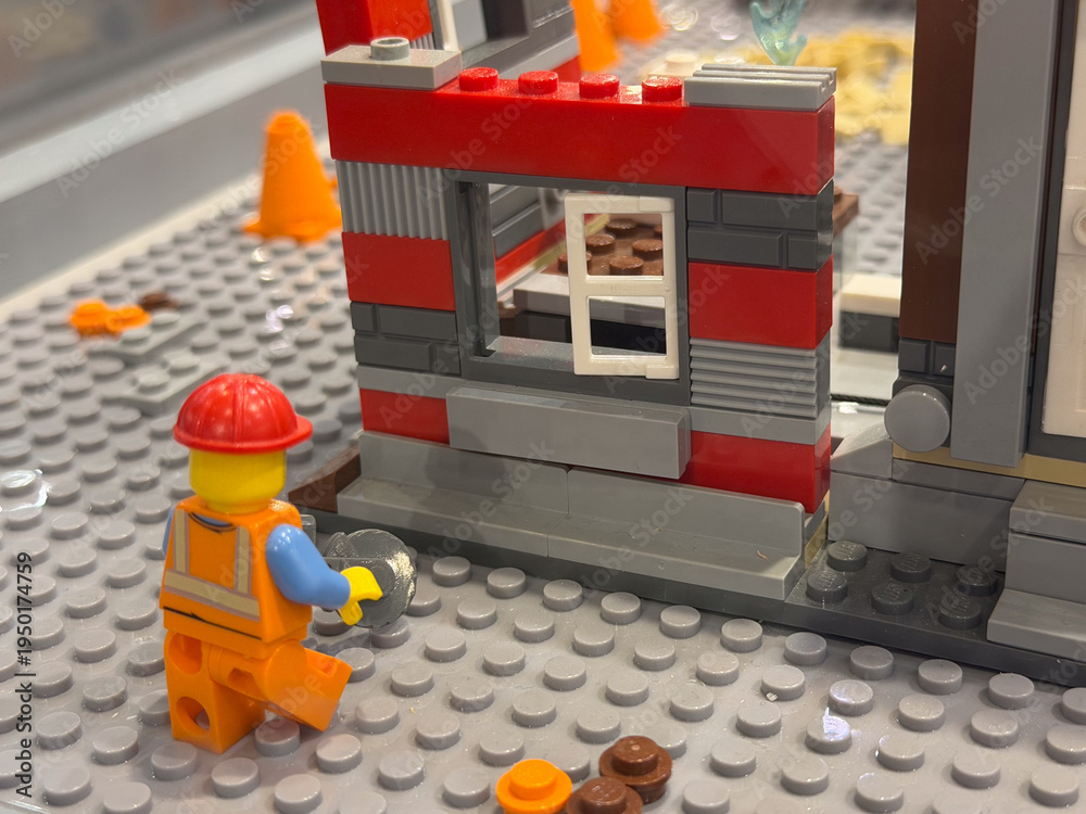 Fototapeta premium Lego worker at a red-and-gray construction wall