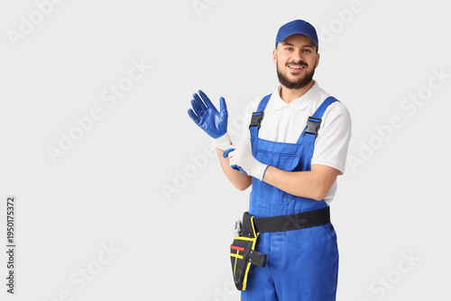 Male worker with gloves on ...