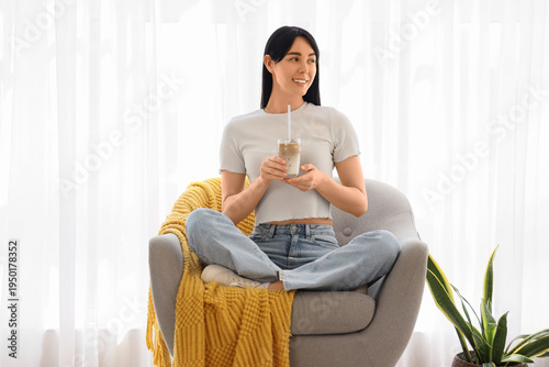 Young woman with glass of i...