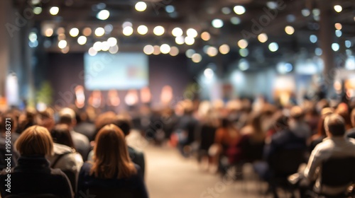 Blurry audience listening at a vibrant conference or seminar event