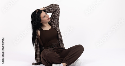 Bild auf Leinwand Woman sitting cross-legged on the floor and looking up