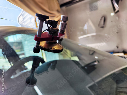 Car glass chip repair tool used for fixing a crack in a windshield at an auto service location