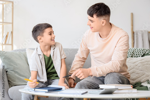 Little boy with male teache...
