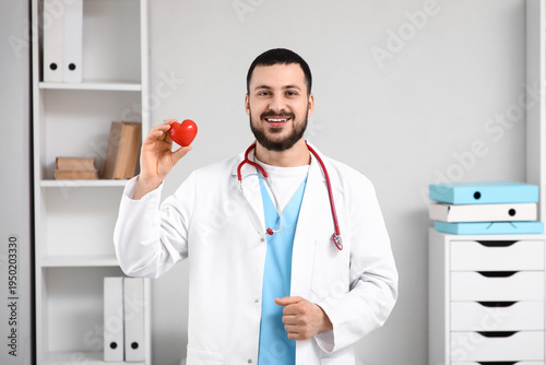 Young happy male doctor wit...