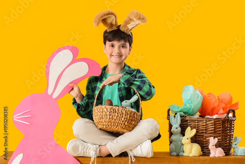 Cute boy in bunny ears with...