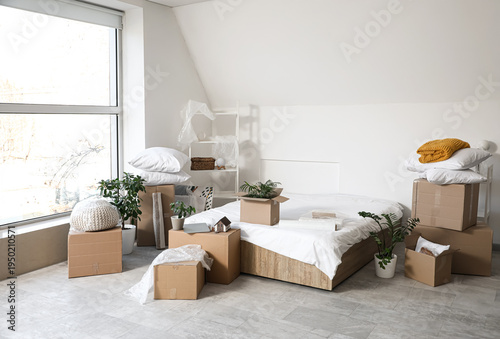 Bed with cardboard boxes an...