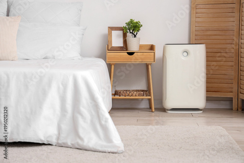 Modern air purifier near ta...