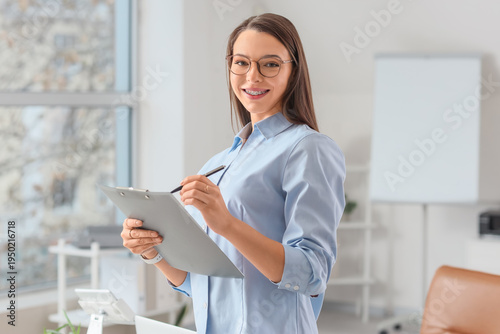 Beautiful secretary writing...