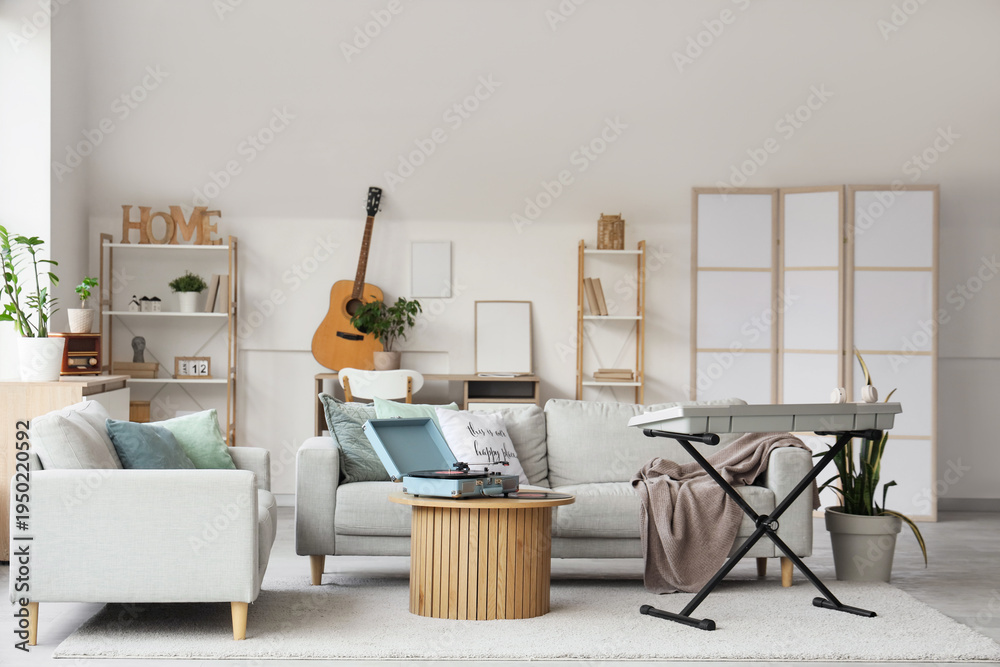 Fototapeta premium Interior of light living room with sofas, table and musical instruments