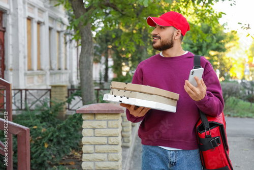 Male courier with pizza box...