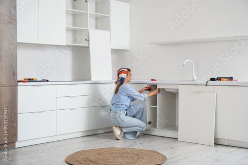 Young woman with screwdrive...