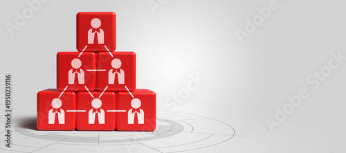 Red cubes with human figure icons stacked in a pyramid shape, representing organizational structure, team management, and corporate leadership concepts