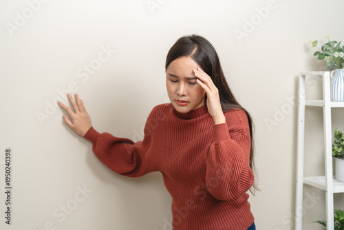 Quadro su tela A woman is feeling dizzy and losing balance while standing.
