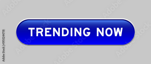 Blue color capsule shape button with word trending now on gray background