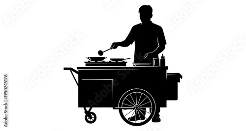 A silhouetted street food vendor cooking with a wok on a cart
