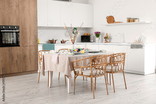 Interior of modern kitchen with festive table serving for Easter celebration