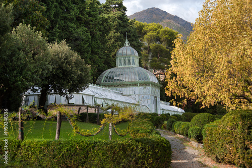 Large glass greenhouse in the Arenzano Municipal Park near historic villa of Negrotto Cambiazo in Italy.