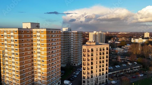 A close up aerial clip of a drone flying in between high rise apartment blocks in London. UK.