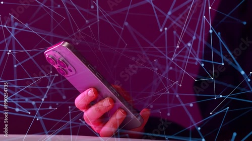 Hand holding a smartphone with digital lines and connections in a purple background at night.