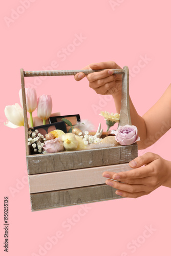 Woman holding wooden basket...