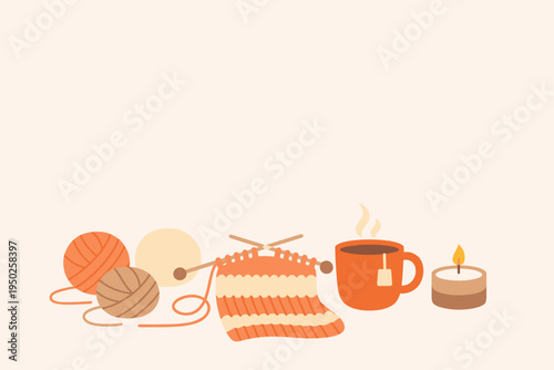 Cozy knitting scene with yarn balls, tea, and candle