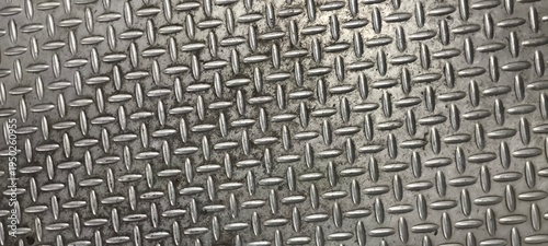The diamond plate  also known as tread plate or checkered steel plate. which is a type of metal stock with a regular pattern of raised diamonds or lines on one side.