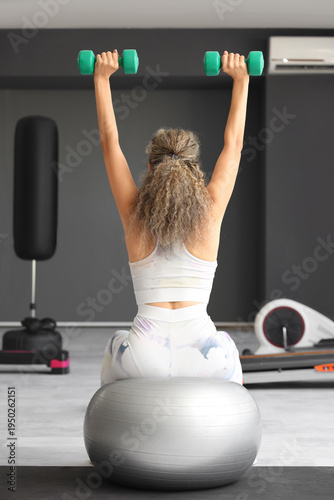 Adult woman exercising with...