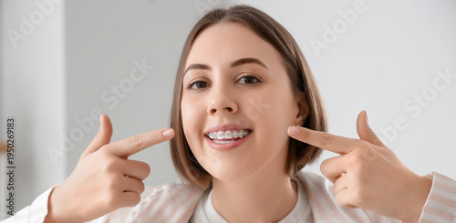 Young woman pointing at her...