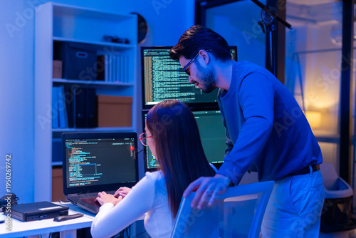 Asian software engineer or programmer team working late in development office,problem solving or algorithm of ai assistant helping for work.software developer,digital technology security concept