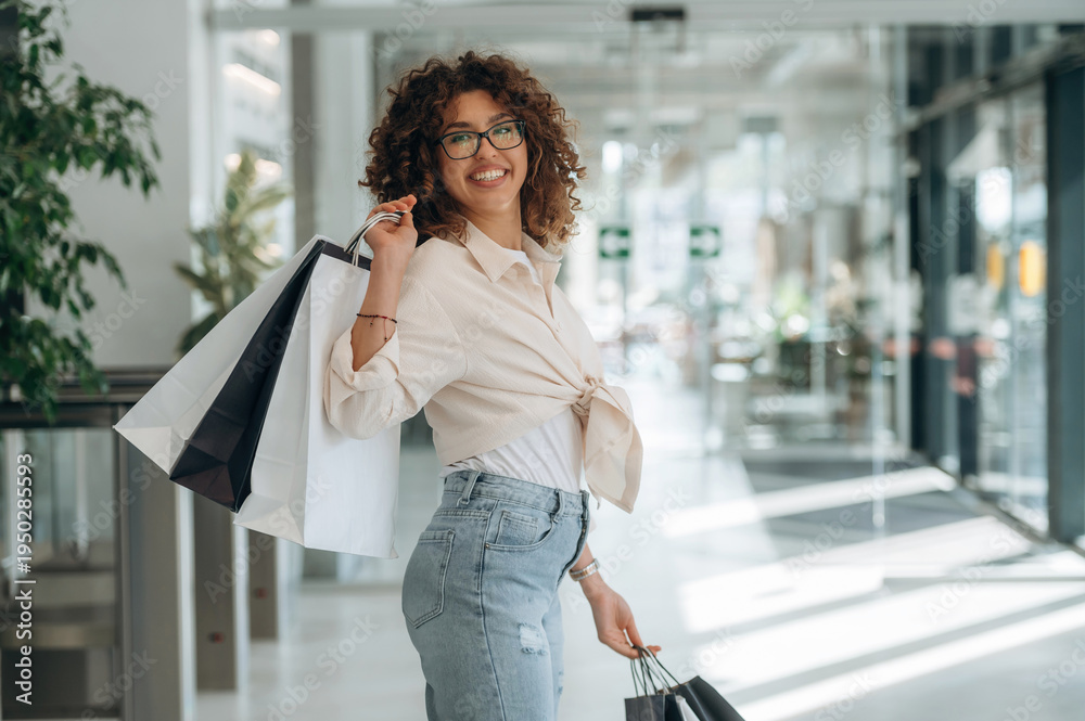 Fototapeta premium Woman is with shopping bags indoors in the supermarket